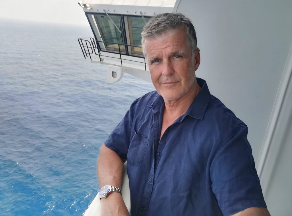 Dominic Pierse on the balcony of a cruise ship